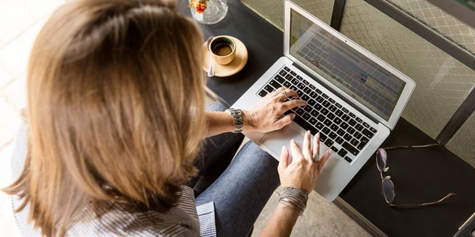 Person using a laptop to search an online lawyer register Person using a laptop to search an online lawyer register